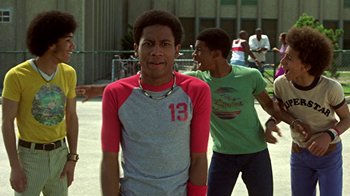 Movie still from “Roll Bounce” (2005), directed by Malcolm D. Lee – Two young men are playing a game in a park; Medium shot, Low angle