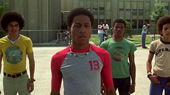 Movie still from “Roll Bounce” (2005), directed by Malcolm D. Lee – Two young men are standing in front of a building; Medium shot, Low angle