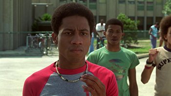 Movie still from “Roll Bounce” (2005), directed by Malcolm D. Lee – Two young men standing next to each other on a sidewalk; Close Up shot, Low angle