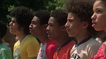 Movie still from “Roll Bounce” (2005), directed by Malcolm D. Lee – A group of young men standing next to each other; Close Up shot, Low angle