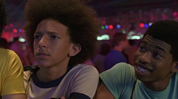 Movie still from “Roll Bounce” (2005), directed by Malcolm D. Lee – Two young men sitting next to each other in a room; Close Up shot, Low angle