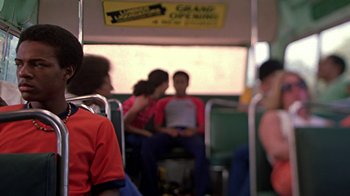 Movie still from “Roll Bounce” (2005), directed by Malcolm D. Lee – Two people sitting on a public transit bus; Medium shot, Over the shoulder angle