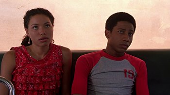 Movie still from “Roll Bounce” (2005), directed by Malcolm D. Lee – A man and a woman sitting next to each other on a couch; Close Up shot, Low angle