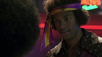 Movie still from “Roll Bounce” (2005), directed by Malcolm D. Lee – A man with a purple and yellow bandanna on his head; Close Up shot, Over the shoulder angle