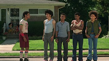 Movie still from “Roll Bounce” (2005), directed by Malcolm D. Lee – A group of young men standing next to each other on a sidewalk; Wide shot, Low angle