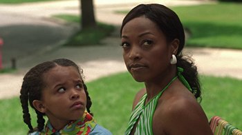 Movie still from “Roll Bounce” (2005), directed by Malcolm D. Lee – A woman and a girl standing next to each other; Close Up shot, Over the shoulder angle