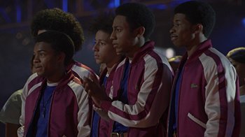 Movie still from “Roll Bounce” (2005), directed by Malcolm D. Lee – A group of young men standing next to each other; Medium shot, Low angle