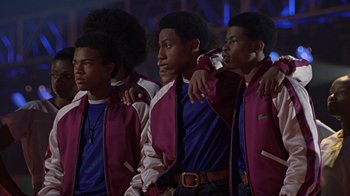 Movie still from “Roll Bounce” (2005), directed by Malcolm D. Lee – A group of young men standing next to each other; Medium shot, Low angle
