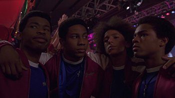 Movie still from “Roll Bounce” (2005), directed by Malcolm D. Lee – A group of young men standing next to each other; Medium shot, Low angle