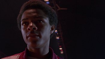 Movie still from “Roll Bounce” (2005), directed by Malcolm D. Lee – A young man is looking into the distance; Close Up shot, Low angle