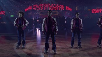Movie still from “Roll Bounce” (2005), directed by Malcolm D. Lee – A group of men riding skateboards on a dance floor; Wide shot, Low angle
