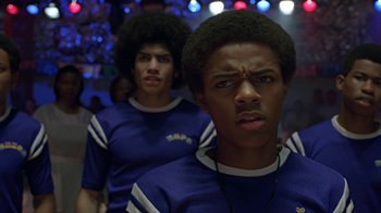 Movie still from “Roll Bounce” (2005), directed by Malcolm D. Lee – Two young men are standing in front of a crowd; Close Up shot, Low angle