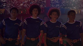 Movie still from “Roll Bounce” (2005), directed by Malcolm D. Lee – A group of young men standing next to each other; Medium shot, Low angle