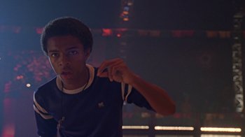 Movie still from “Roll Bounce” (2005), directed by Malcolm D. Lee – A young man holding a white string in his hand; Close Up shot, Low angle