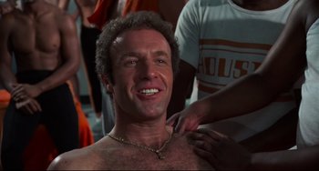 Movie still from “Rollerball” (1975), directed by Norman Jewison – A person with a necklace; Close Up shot, Low angle