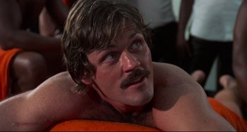 Movie still from “Rollerball” (1975), directed by Norman Jewison – A person laying on a bed; Close Up shot, Low angle