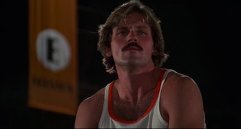 Movie still from “Rollerball” (1975), directed by Norman Jewison – A person with a beard and mustache; Close Up shot, Low angle
