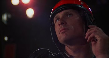 Movie still from “Rollerball” (1975), directed by Norman Jewison – A person wearing a helmet; Close Up shot, Low angle