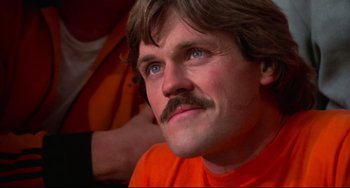 Movie still from “Rollerball” (1975), directed by Norman Jewison – A person with a mustache; Close Up shot, Low angle