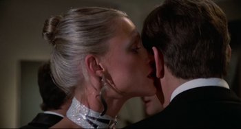 Movie still from “Rollerball” (1975), directed by Norman Jewison – A woman and a young man kissing in a room; Close Up shot, Over the shoulder angle