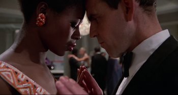 Movie still from “Rollerball” (1975), directed by Norman Jewison – A man and a woman holding hands in front of each other; Close Up shot, Low angle