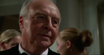 Movie still from “Rollerball” (1975), directed by Norman Jewison – An older man and a young girl are looking at the camera; Close Up shot, Low angle