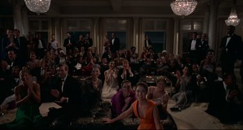 Movie still from “Rollerball” (1975), directed by Norman Jewison – A group of people sitting in a living room; Wide shot, High angle