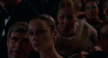 Movie still from “Rollerball” (1975), directed by Norman Jewison – Two beautiful women sitting next to each other in a dark room; Close Up shot, Low angle