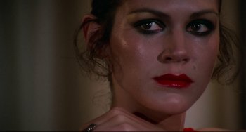 Movie still from “Rollerball” (1975), directed by Norman Jewison – A person wearing makeup and a ring; Close Up shot, Low angle