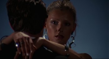 Movie still from “Rollerball” (1975), directed by Norman Jewison – A person holding another person's arm; Close Up shot, Low angle