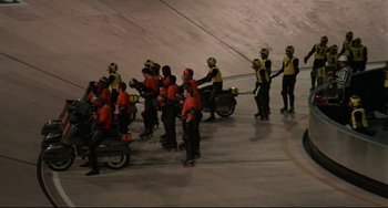 A group of people on snowboards and scooters in the snow