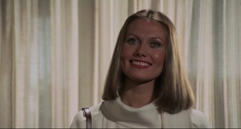 Movie still from “Rollerball” (1975), directed by Norman Jewison – A beautiful woman with long blonde hair wearing a white shirt; Close Up shot, High angle