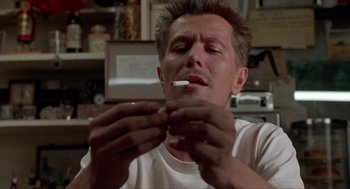 Movie still from “Romeo Is Bleeding” (1993), directed by Peter Medak – A person holding a cigarette in his mouth; Close Up shot, Low angle