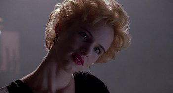 Movie still from “Romeo Is Bleeding” (1993), directed by Peter Medak – A person with curly hair; Close Up shot, Low angle