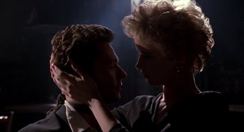 Movie still from “Romeo Is Bleeding” (1993), directed by Peter Medak – A man and a woman are touching heads in the dark; Close Up shot, Low angle