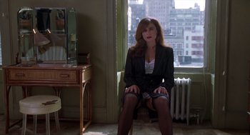 Movie still from “Romeo Is Bleeding” (1993), directed by Peter Medak – A woman sitting on a chair in front of a window; Medium shot, High angle