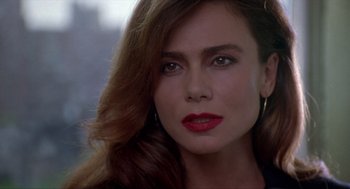 Movie still from “Romeo Is Bleeding” (1993), directed by Peter Medak – A person wearing a black jacket; Close Up shot, Over the shoulder angle