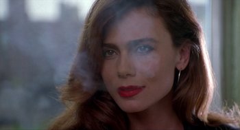 Movie still from “Romeo Is Bleeding” (1993), directed by Peter Medak – A person with long brown hair; Close Up shot, Over the shoulder angle