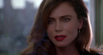 Movie still from “Romeo Is Bleeding” (1993), directed by Peter Medak – A person wearing a red lipstick; Close Up shot, Over the shoulder angle