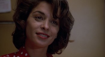 Movie still from “Romeo Is Bleeding” (1993), directed by Peter Medak – A woman's face in a red shirt; Close Up shot, Low angle