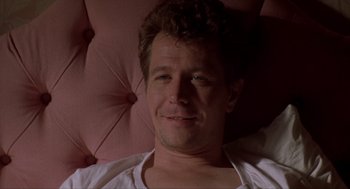 Movie still from “Romeo Is Bleeding” (1993), directed by Peter Medak – A person laying in a bed; Close Up shot, Low angle