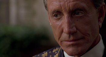Movie still from “Romeo Is Bleeding” (1993), directed by Peter Medak – A person wearing a military uniform; Close Up shot, Low angle