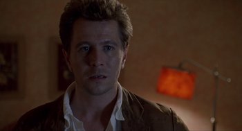 Movie still from “Romeo Is Bleeding” (1993), directed by Peter Medak – A person wearing a jacket; Close Up shot, Low angle