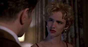 Movie still from “Romeo Is Bleeding” (1993), directed by Peter Medak – A man and a woman looking at one another in front of a mirror; Close Up shot, Over the shoulder angle