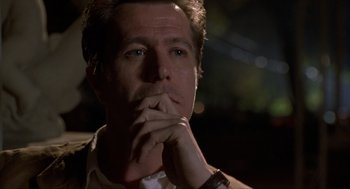 Movie still from “Romeo Is Bleeding” (1993), directed by Peter Medak – A person with his hand under his chin; Close Up shot, Low angle
