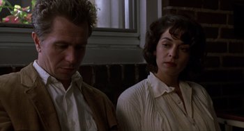 Movie still from “Romeo Is Bleeding” (1993), directed by Peter Medak – A man and a woman standing next to each other; Close Up shot, Low angle
