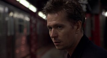 Movie still from “Romeo Is Bleeding” (1993), directed by Peter Medak – A person wearing a black shirt; Close Up shot, Low angle