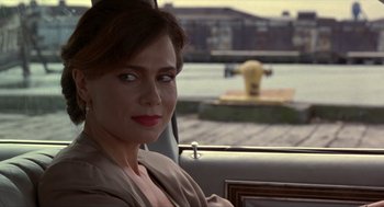 Movie still from “Romeo Is Bleeding” (1993), directed by Peter Medak – A woman sitting in the back seat of a car; Close Up shot, Over the shoulder angle