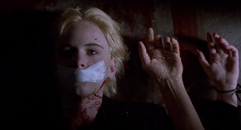 Movie still from “Romeo Is Bleeding” (1993), directed by Peter Medak – A person with blood on their face and mouth; Close Up shot, Low angle