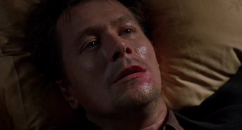 Movie still from “Romeo Is Bleeding” (1993), directed by Peter Medak – A person laying on a bed; Close Up shot, Low angle